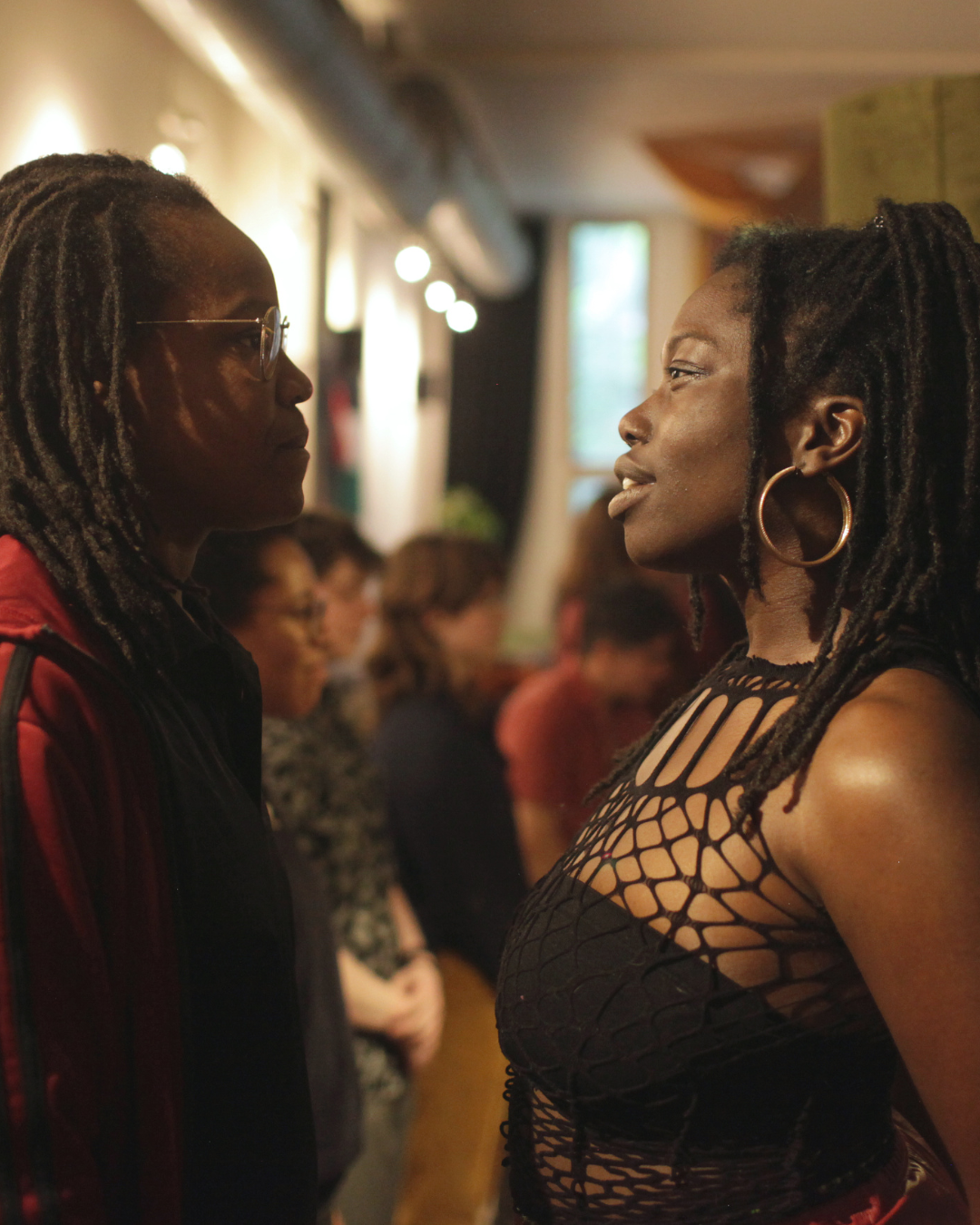 Two people stand in front of each other looking at each other intensely